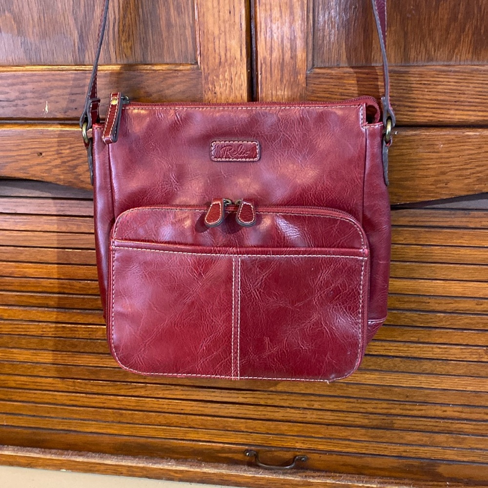 Relic red faux leather purse with inside and outside compartments.
